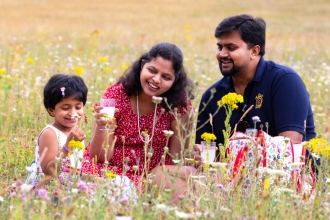 Family picnicking in wildflowers
