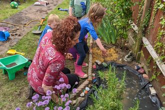 Family looking at a garden pond