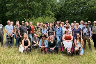 Staff and Trustees of Herts and Middlesex Wildlife Trust standing together for a group photo at Danemead Nature Reserve
