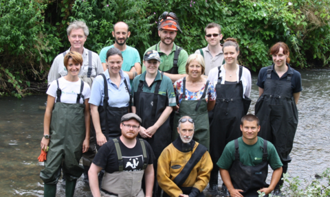 Living River Volunteer Group posing for a picture on a river