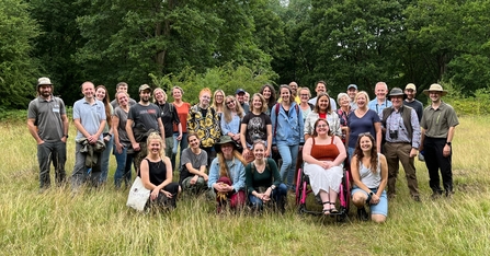 Staff and Trustees of Herts and Middlesex Wildlife Trust standing together for a group photo at Danemead Nature Reserve